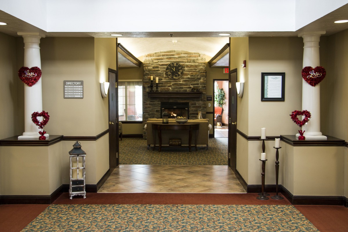 A cozy lobby area featuring a stone fireplace and warm decor.