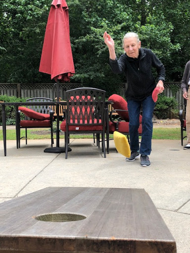 A lively game of cornhole in a backyard setting, showcasing friendly competition and outdoor fun.