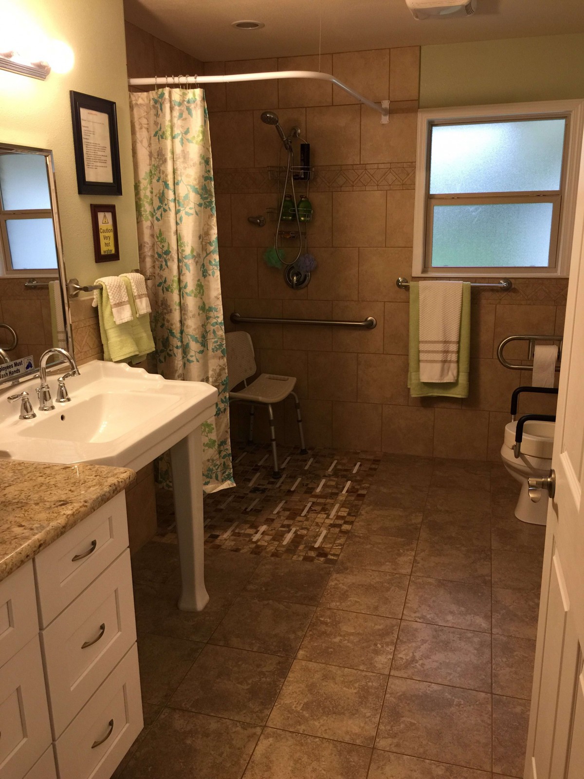 A well-organized bathroom with a sink, shower, and towel rack.