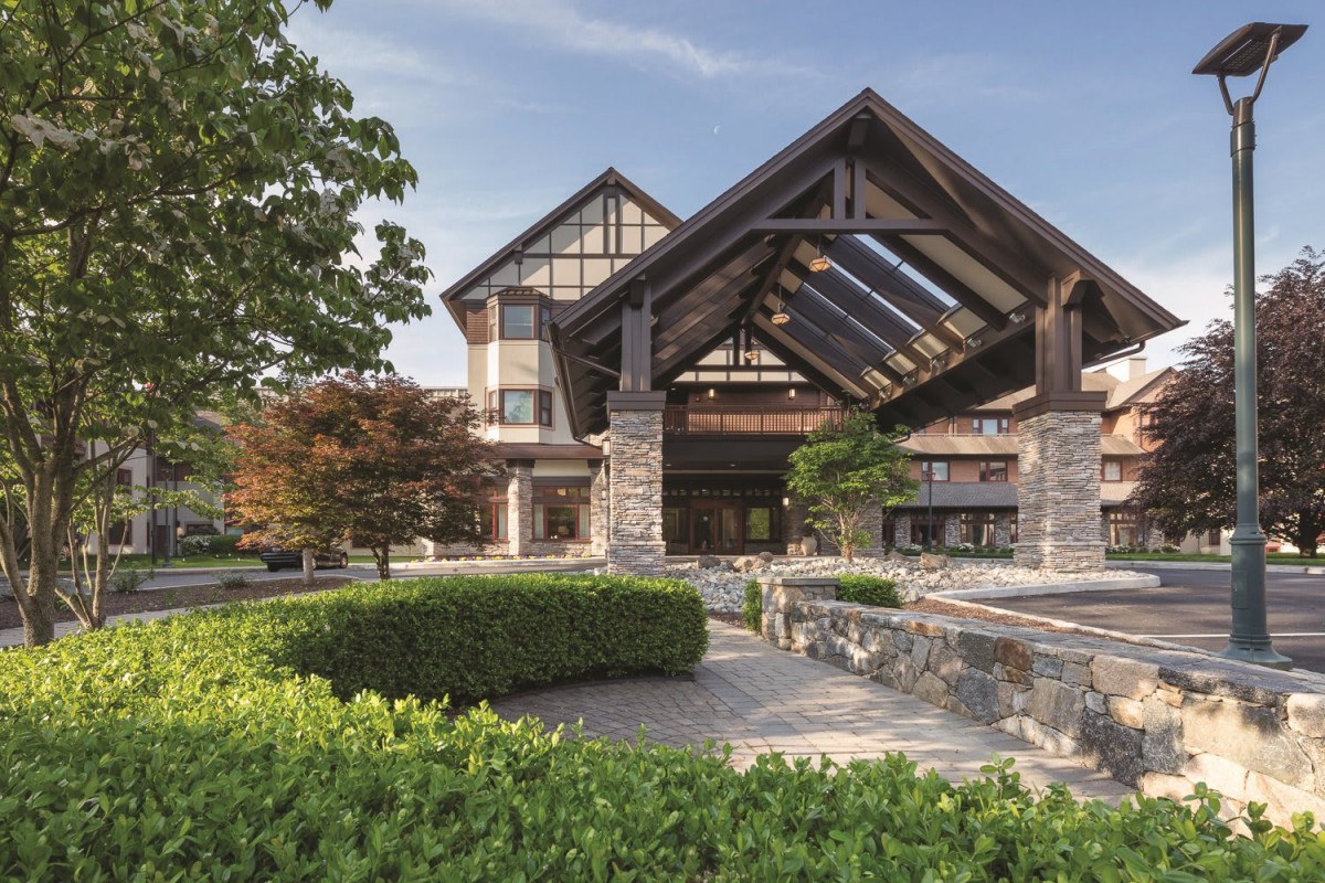 A modern building with an impressive entrance and well-maintained landscaping.