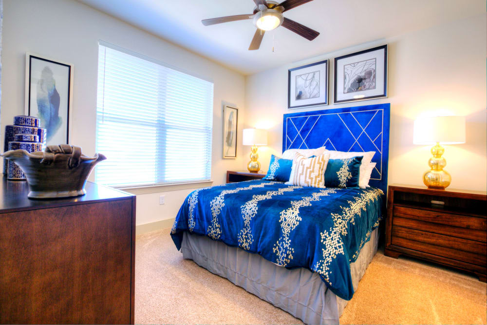 A modern bedroom with blue bedding and stylish decor.