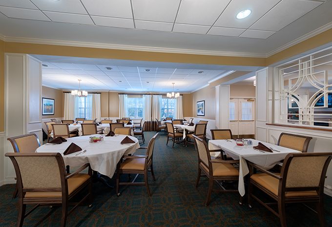 An elegant dining room with neatly arranged tables and chairs.