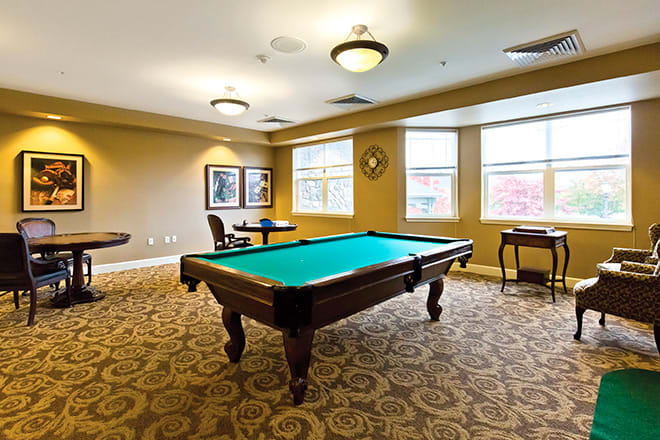 A cozy recreation room featuring a pool table and elegant interior design.