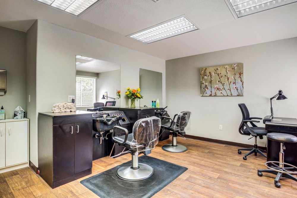 A modern hair salon interior with styling chairs and mirrors.