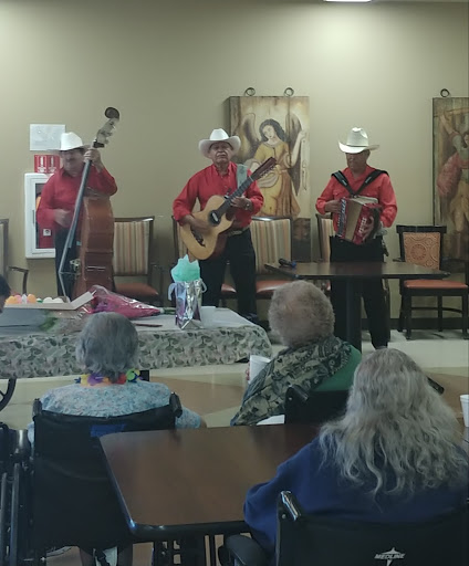 A lively musical performance featuring musicians in traditional attire, entertaining an audience at a community event.