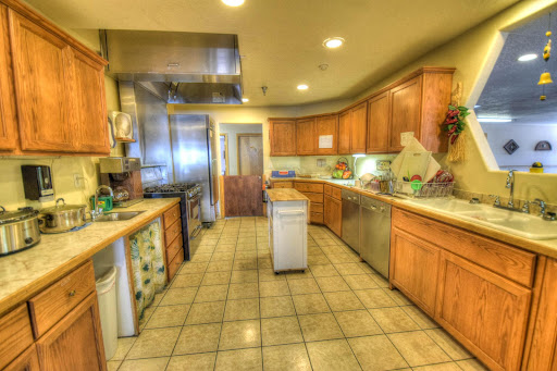A spacious kitchen featuring wooden cabinets and modern appliances, ideal for cooking and entertaining.