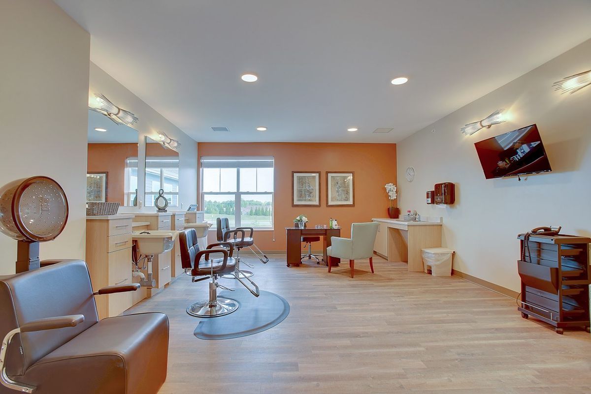 A modern and stylish hair salon with chairs and mirrors, featuring warm lighting and inviting decor.