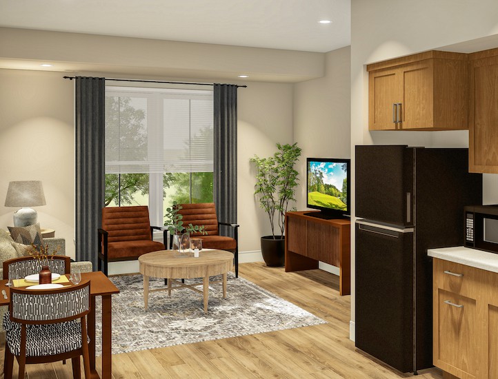 A modern living room with wooden flooring, featuring a television, chairs, and a small dining table.
