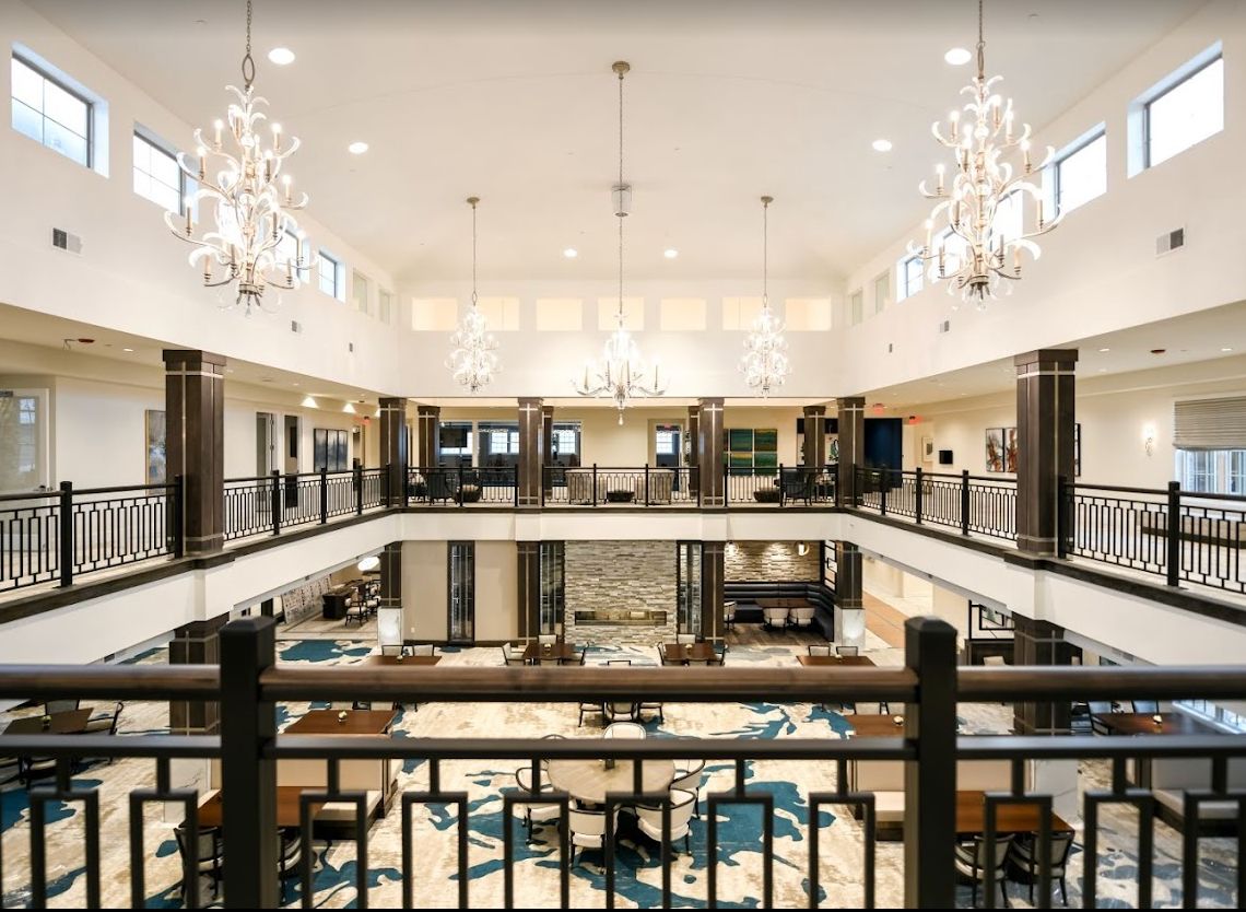 A luxurious hotel lobby with elegant chandeliers and a spacious, modern design.