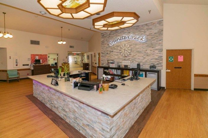 A modern reception desk area with stylish lighting and decor.