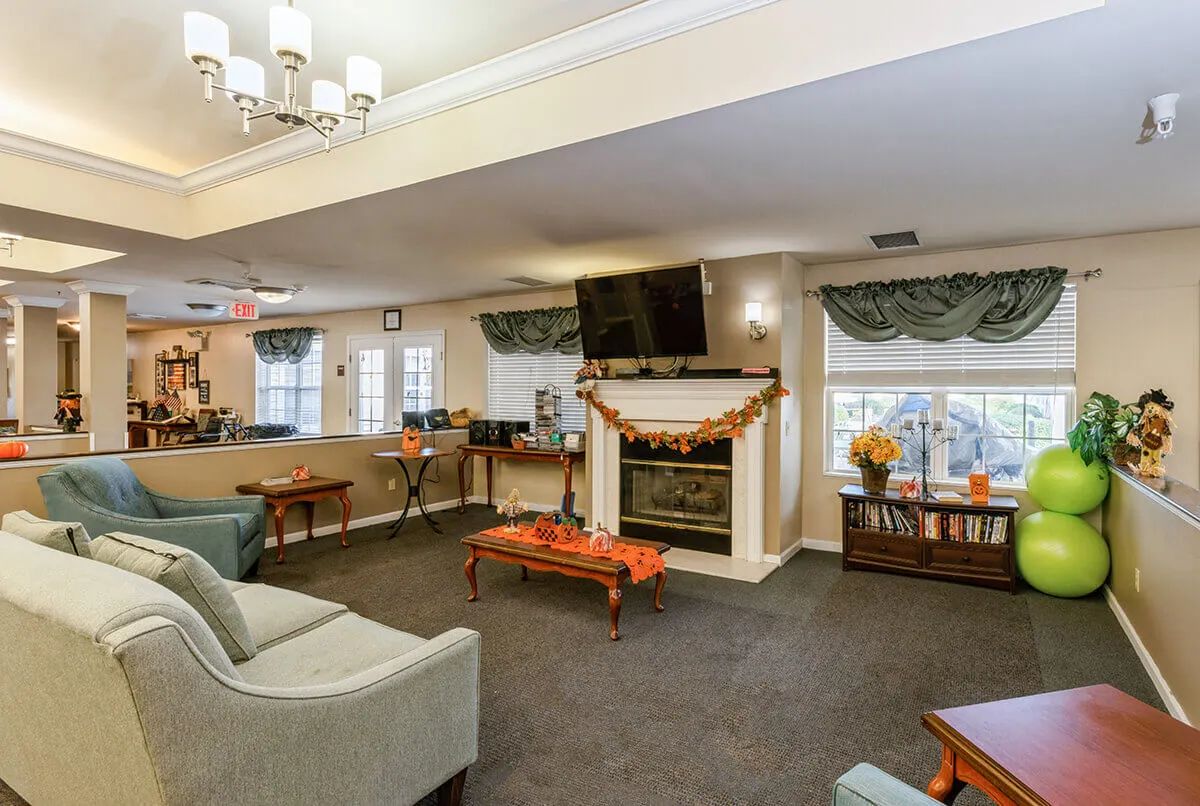 A cozy living room featuring a fireplace, wall-mounted television, and comfortable seating.