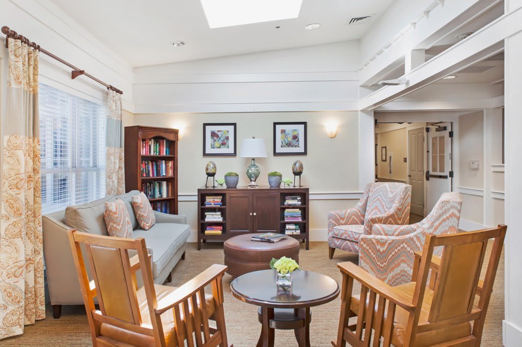 A cozy living room with comfortable seating and a bookshelf.