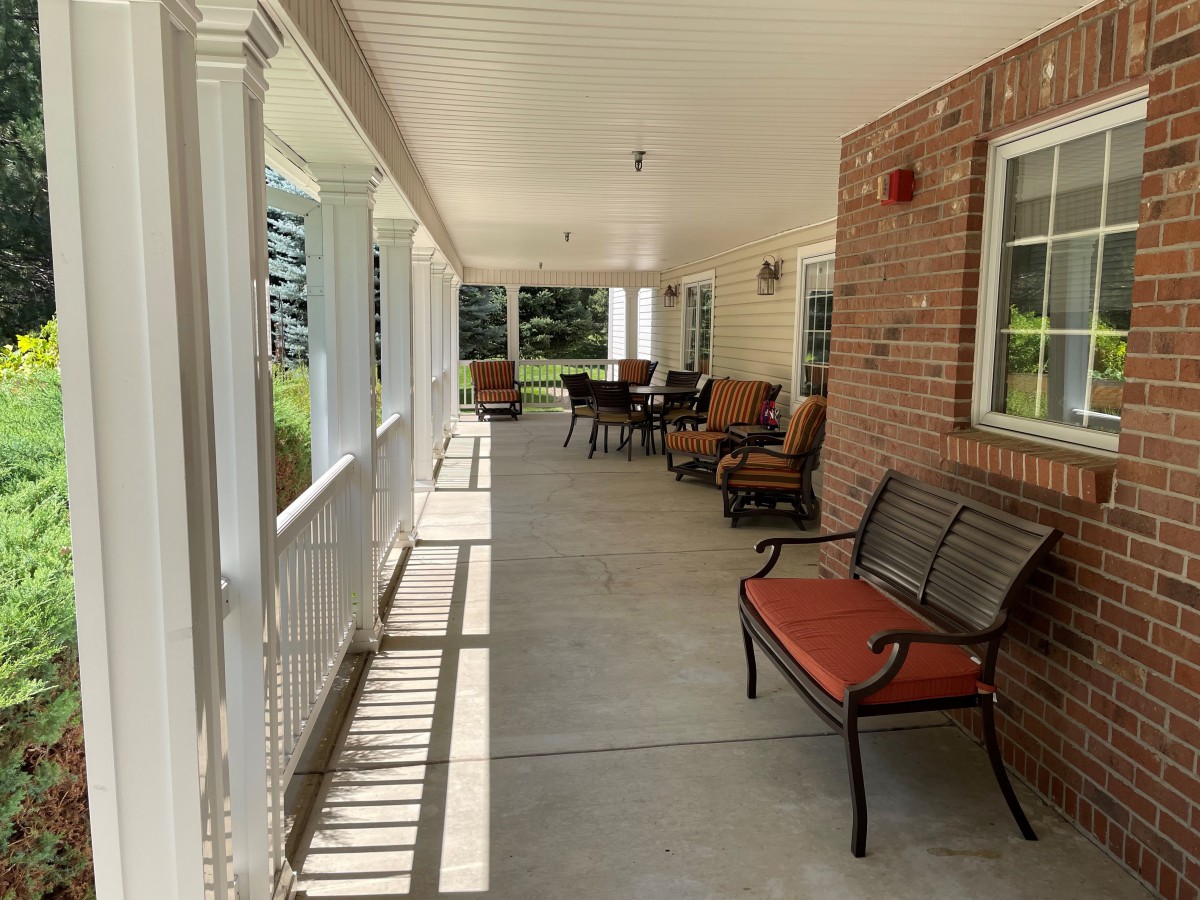 A peaceful porch with comfortable seating and natural sunlight.