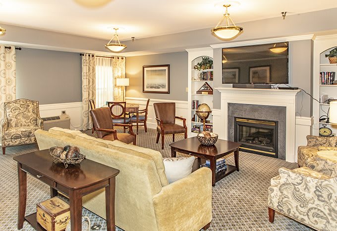 A cozy, modern living room with a fireplace and stylish furniture.