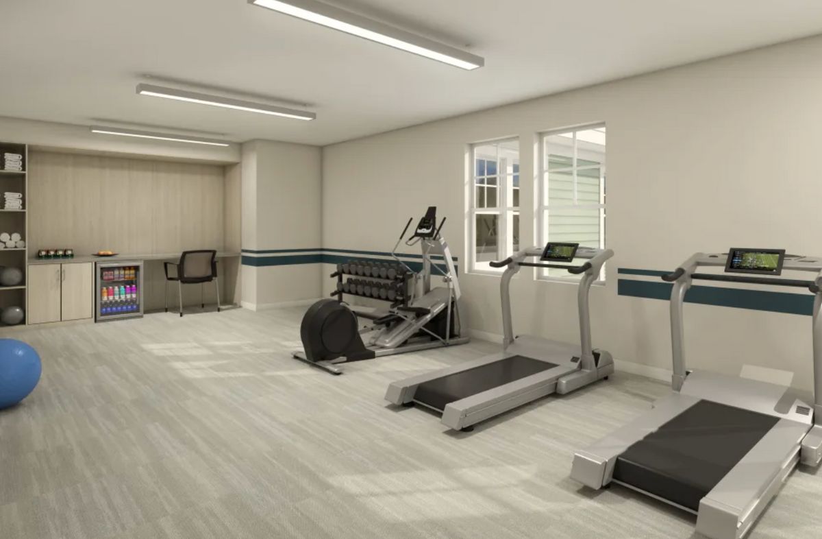 A clean and well-equipped gym with treadmills and exercise machines.
