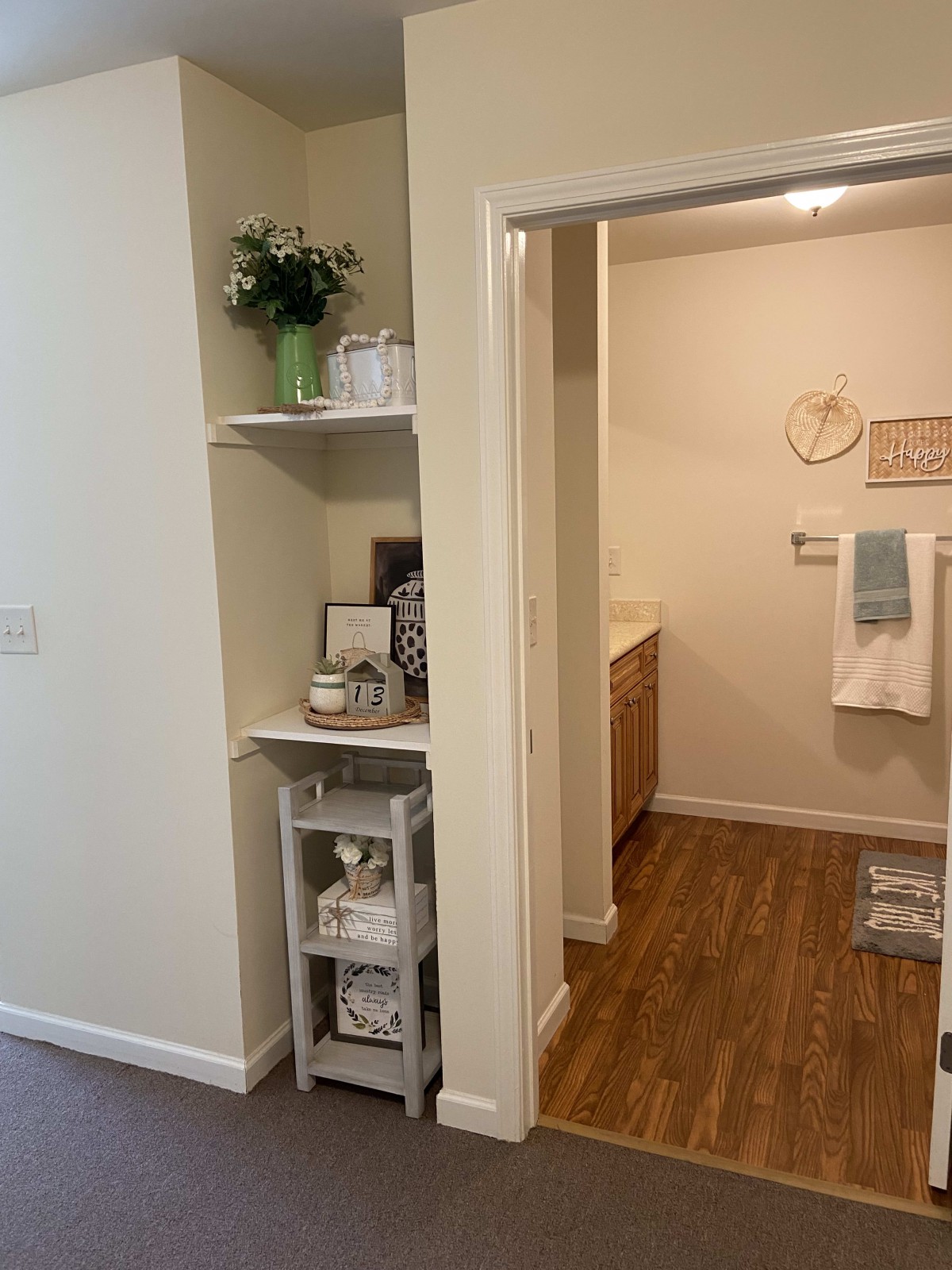 A well-organized bathroom with neatly arranged shelves and decor.