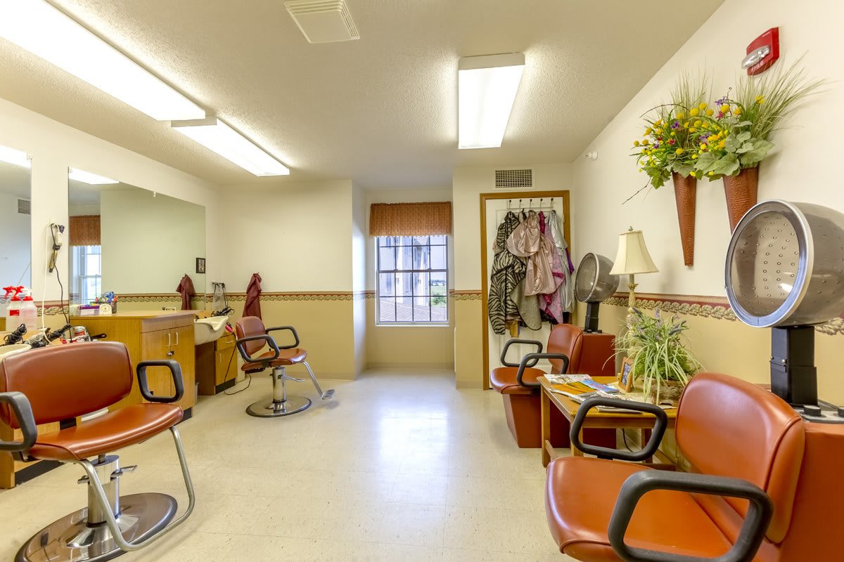 A cozy hair salon with styling chairs and a waiting area.