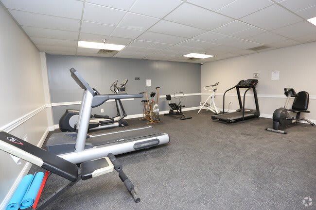 A fitness room equipped with treadmills and stationary bikes.
