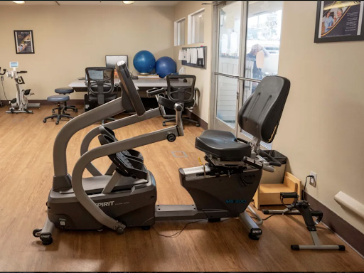 A recumbent exercise bike positioned in a well-lit gym space, perfect for low-impact workouts.