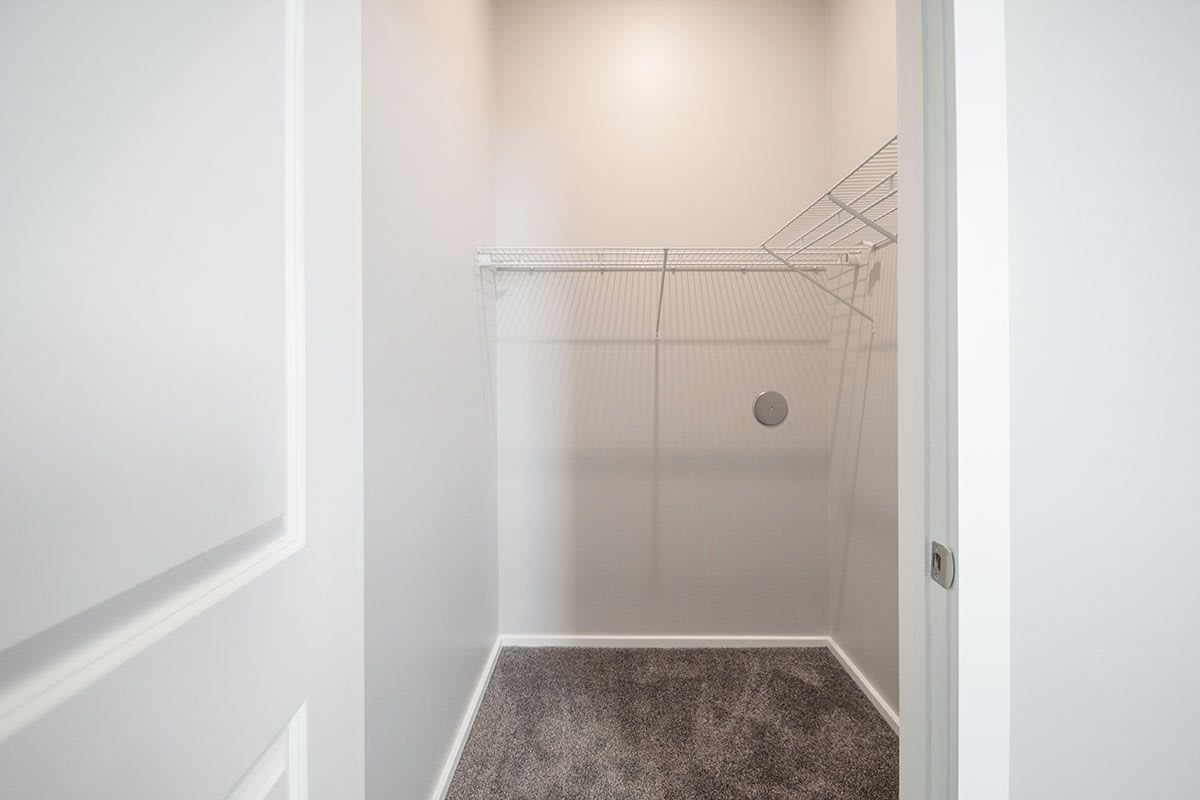 An empty walk-in closet with wire shelving and a closed door.