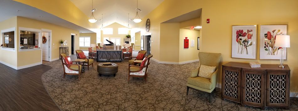 A cozy lounge area with comfortable seating and a grand piano.