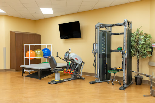 A well-equipped gym area featuring various fitness machines and exercise accessories.