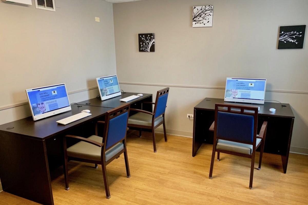 A small computer lab with workstations and chairs arranged neatly.