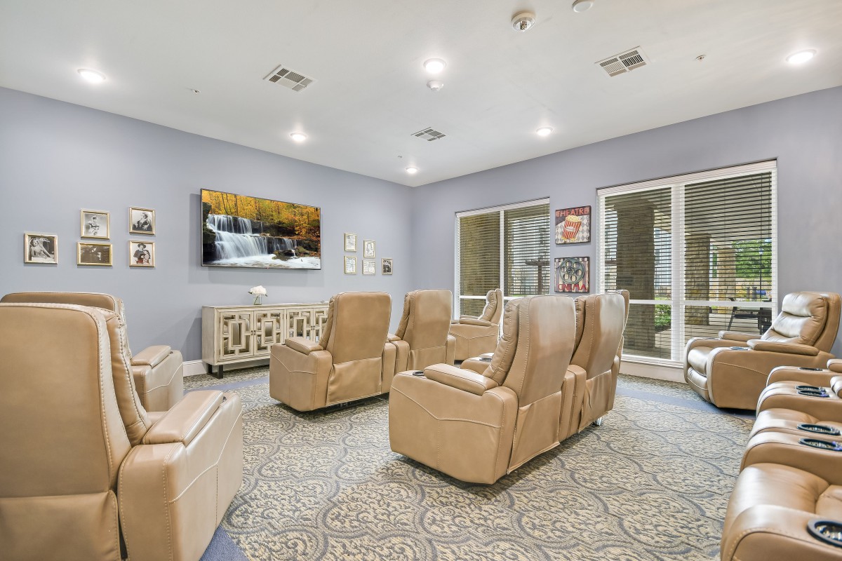 A modern living room with comfortable armchairs and a television.
