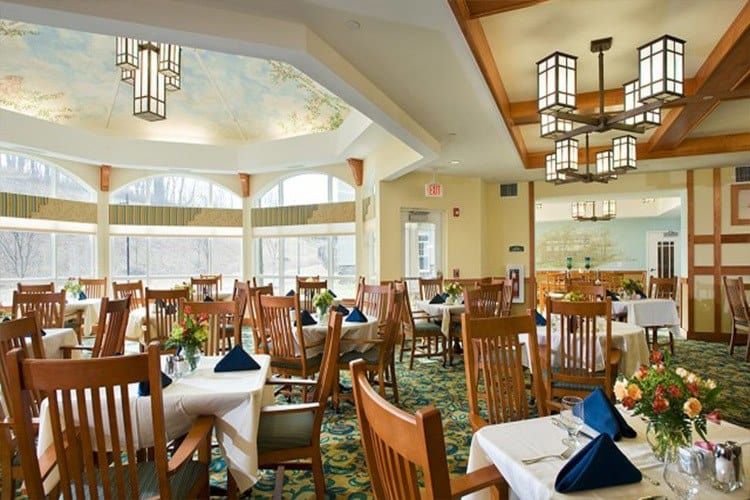 Elegant dining area with neatly arranged tables and large windows.