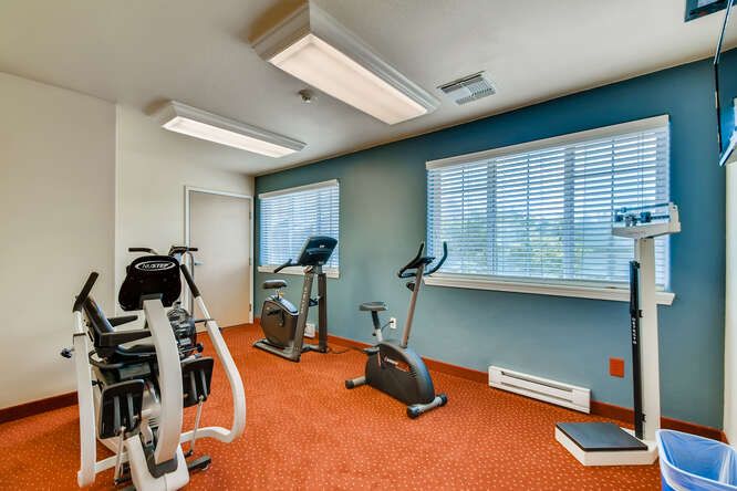 A small indoor gym with stationary bikes and fitness equipment.