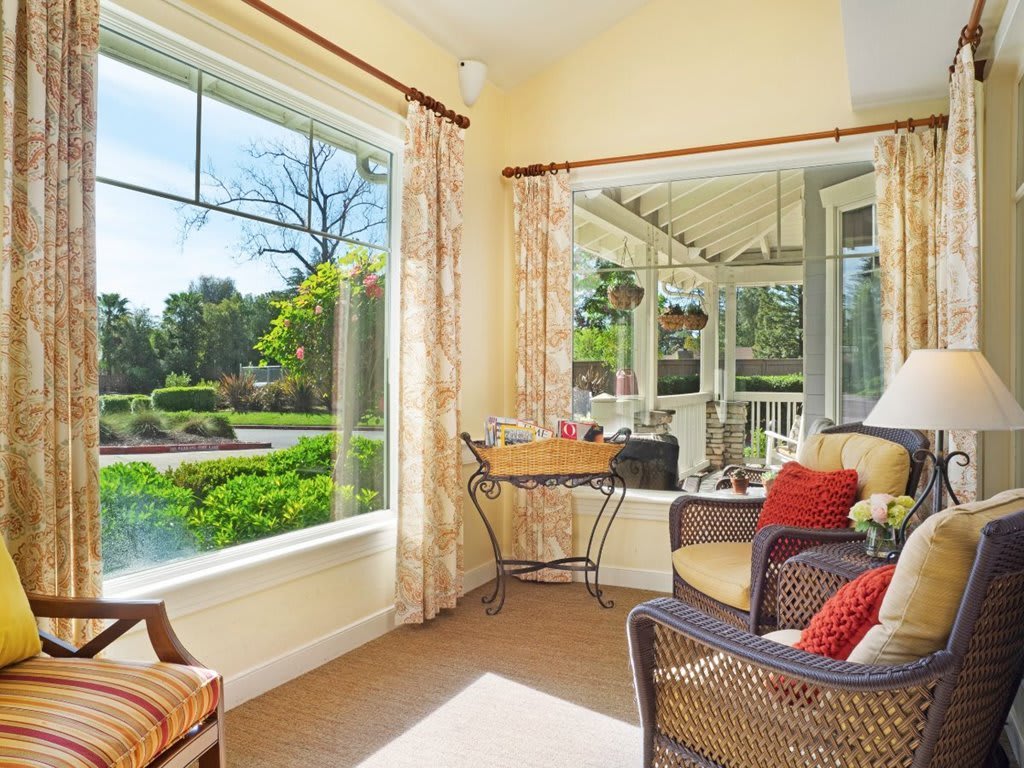A bright and cozy living room with a large window offering a scenic view.