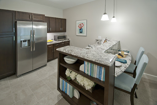 A sleek and modern kitchen featuring stylish appliances and a cozy dining nook.