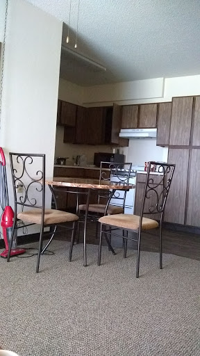 A cozy kitchen setup featuring a quaint dining table and chairs.