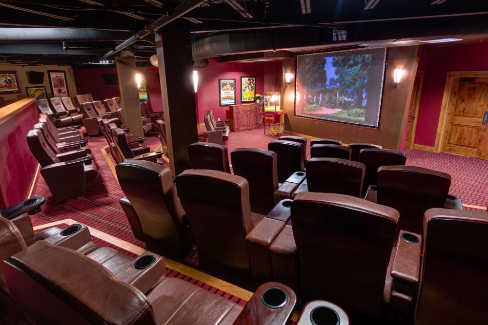 A luxurious home theater setup with comfortable seating and a large movie screen.