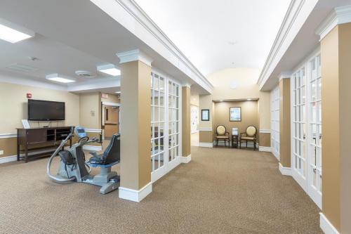 A spacious and well-lit gym area featuring exercise equipment, designed for community recreation.