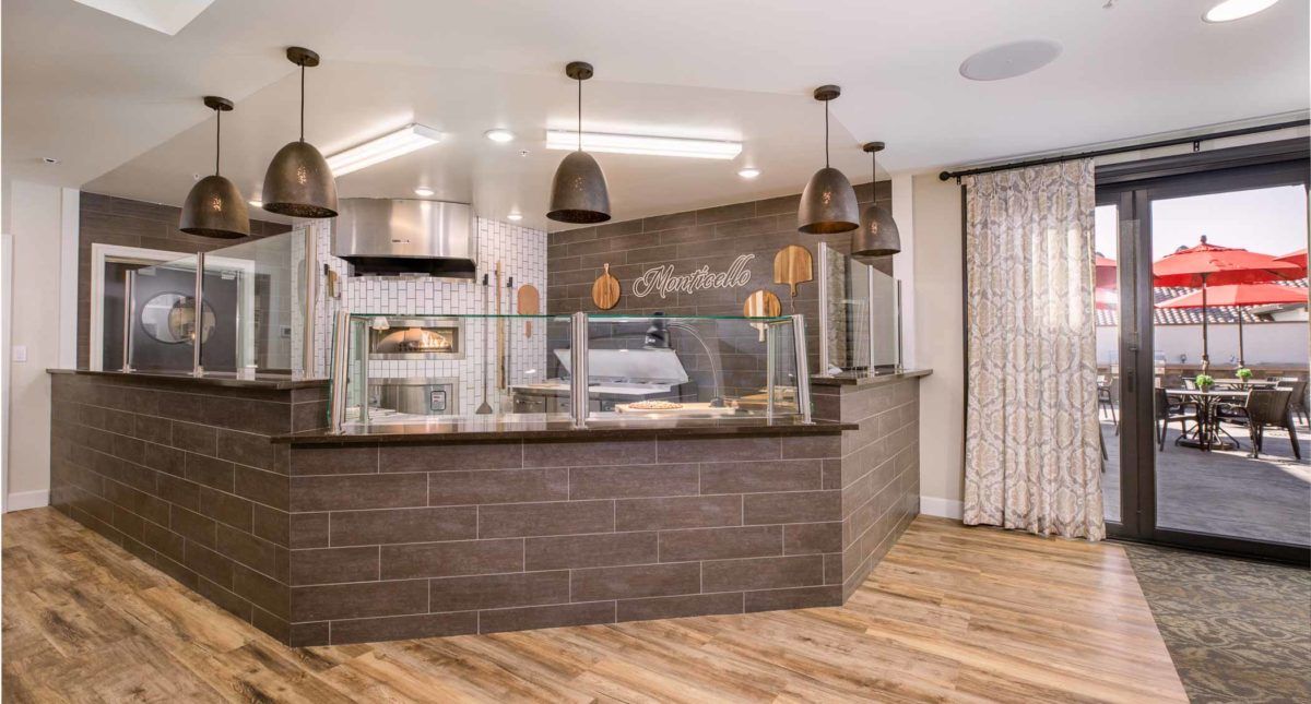 A modern cafe interior with a sleek counter and stylish lighting.