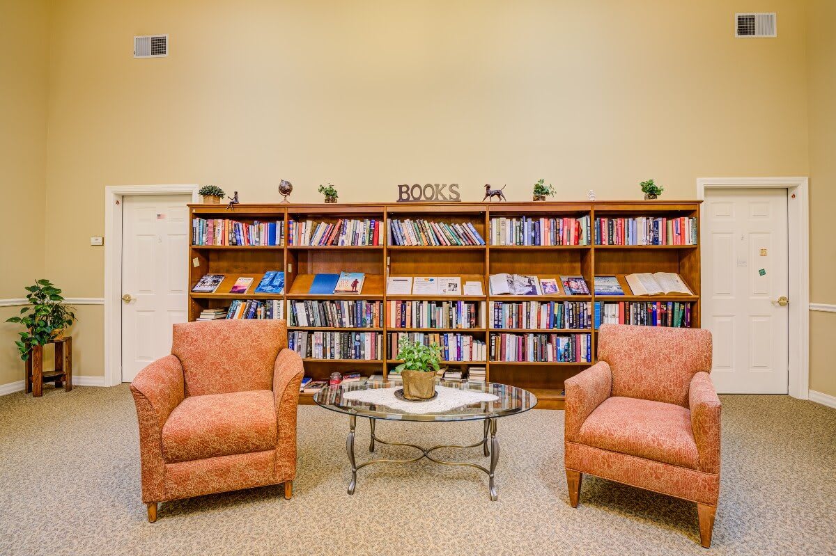 Cozy reading area with bookshelves and comfortable chairs.