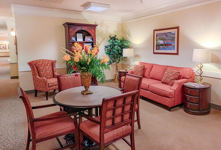 A cozy living room with comfortable seating, decorative flowers, and a welcoming ambiance.