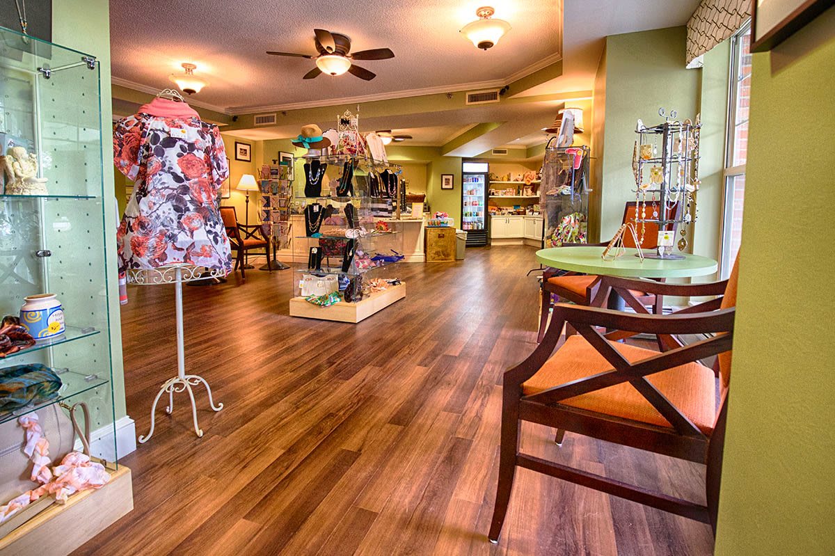 A cozy boutique with mannequins displaying colorful clothing designs.