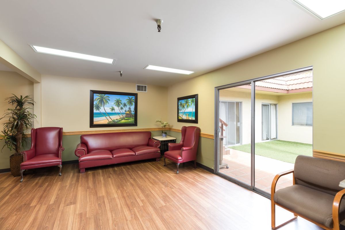 A bright and inviting waiting area featuring comfortable seating and landscape artwork.
