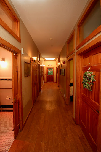 A warm and inviting hallway featuring wooden doors and soft lighting.