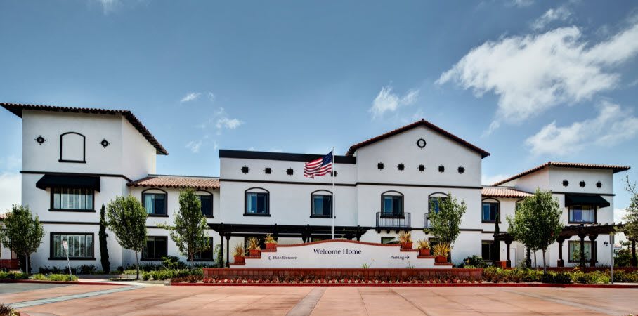 A modern building with an American flag on a clear day.