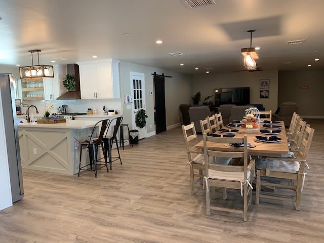 A modern open-concept living space with a kitchen, dining area, and living room.
