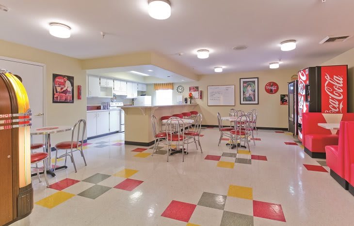 A retro-style diner with colorful tiled flooring and vintage decor.