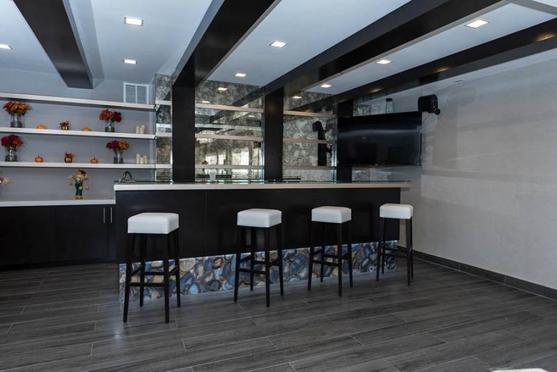 A modern bar interior with high stools and sleek design elements.