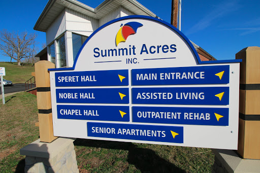 Directional sign for Summit Acres, indicating various facilities including assisted living and senior apartments.