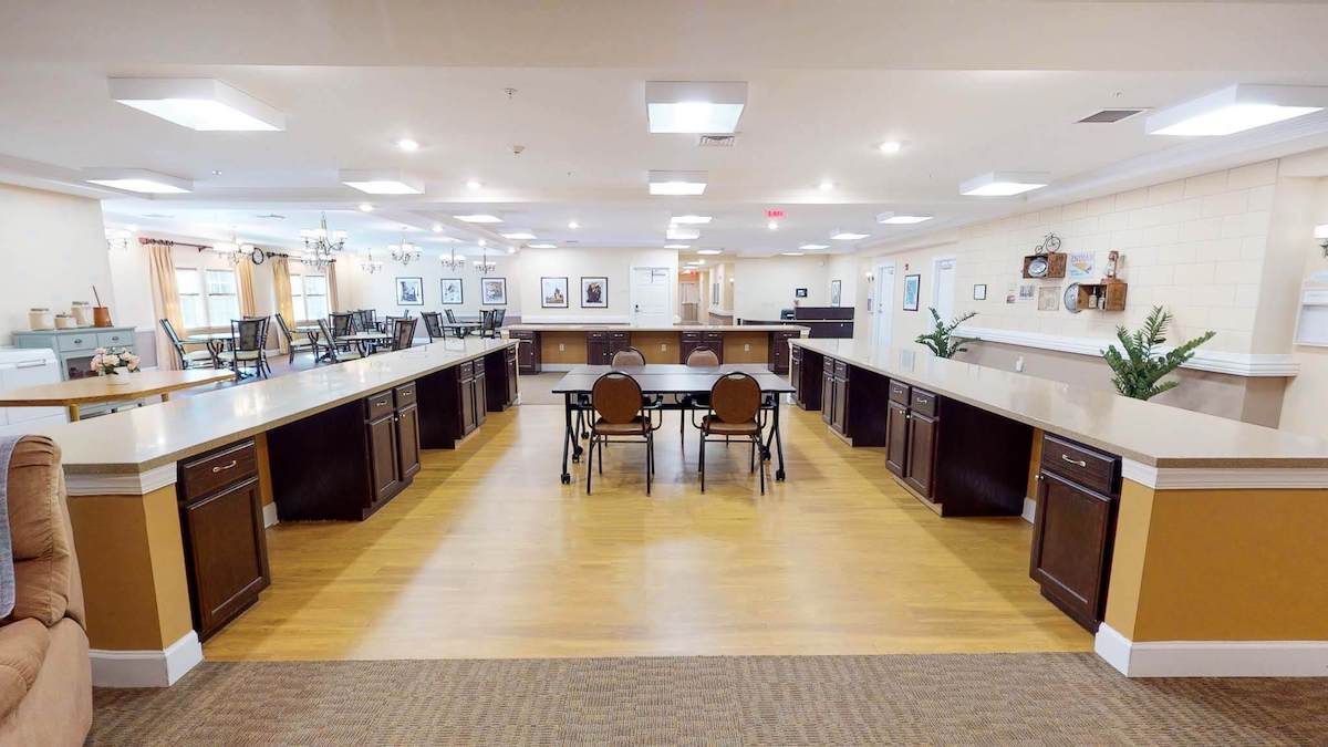 A spacious and modern kitchen interior with an island surrounded by seating.