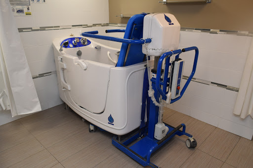 A hydrotherapy bathtub designed for rehabilitation purposes, featuring mobility support.