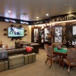 A well-decorated man cave with a sports theme, featuring a large TV and poker table.