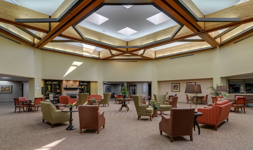 A spacious lobby with comfortable seating and skylights.